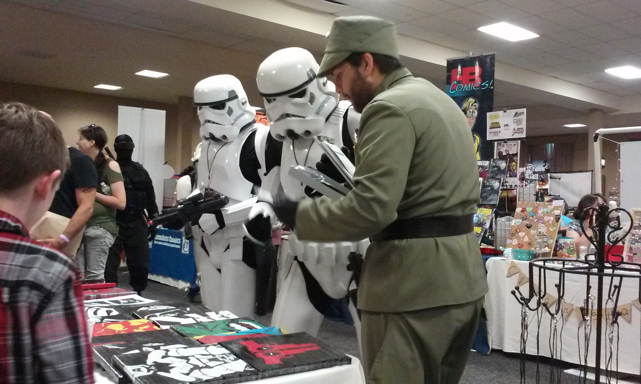 Storm Troopers examining artwork made entirely from duct tape.